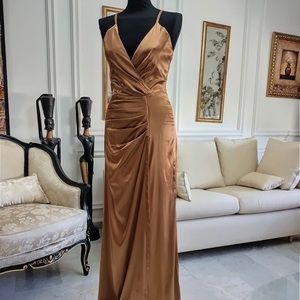 Beautiful bronze gown in a size small. The designer is Naked by Lana L.
